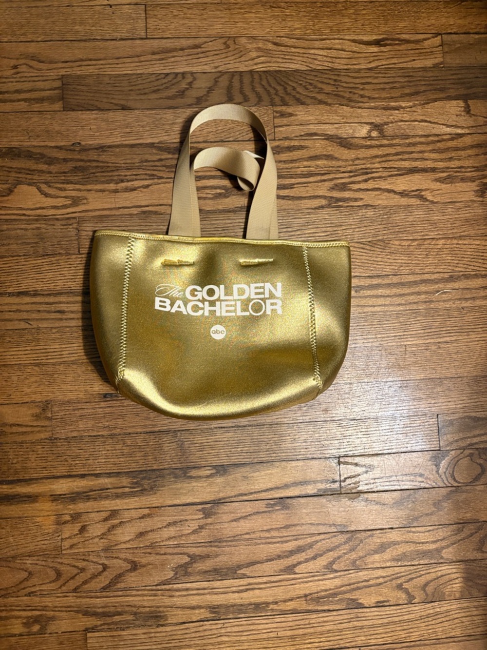 golden "The Golden Bachelor" tote bag is made of neoprene